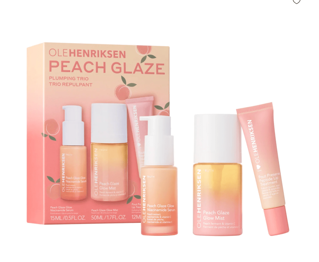 A box of Ole Henriksen Peach Glaze skincare products including a serum, glow mist, and lip treatment, presented in a visually appealing arrangement.