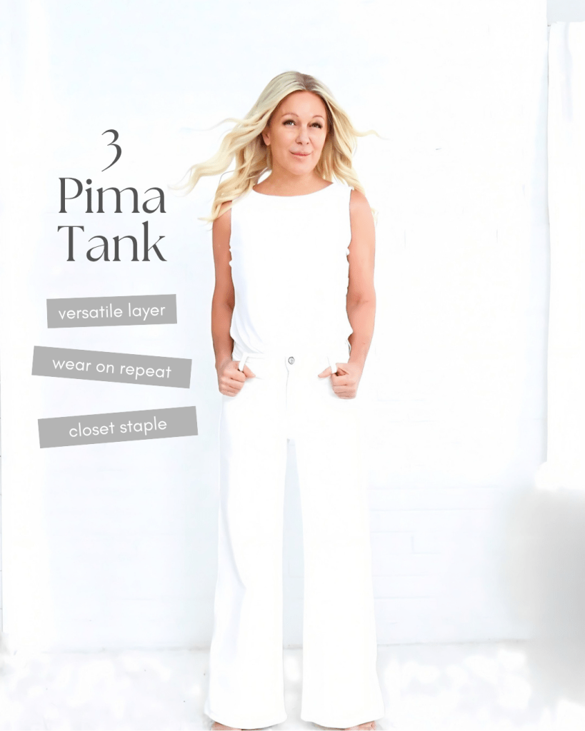 A woman wearing a white tank top and white wide-legged pants, standing against a light backdrop. Promotional text highlights the tank as a versatile layer, suitable for repeated wear, and a closet staple.