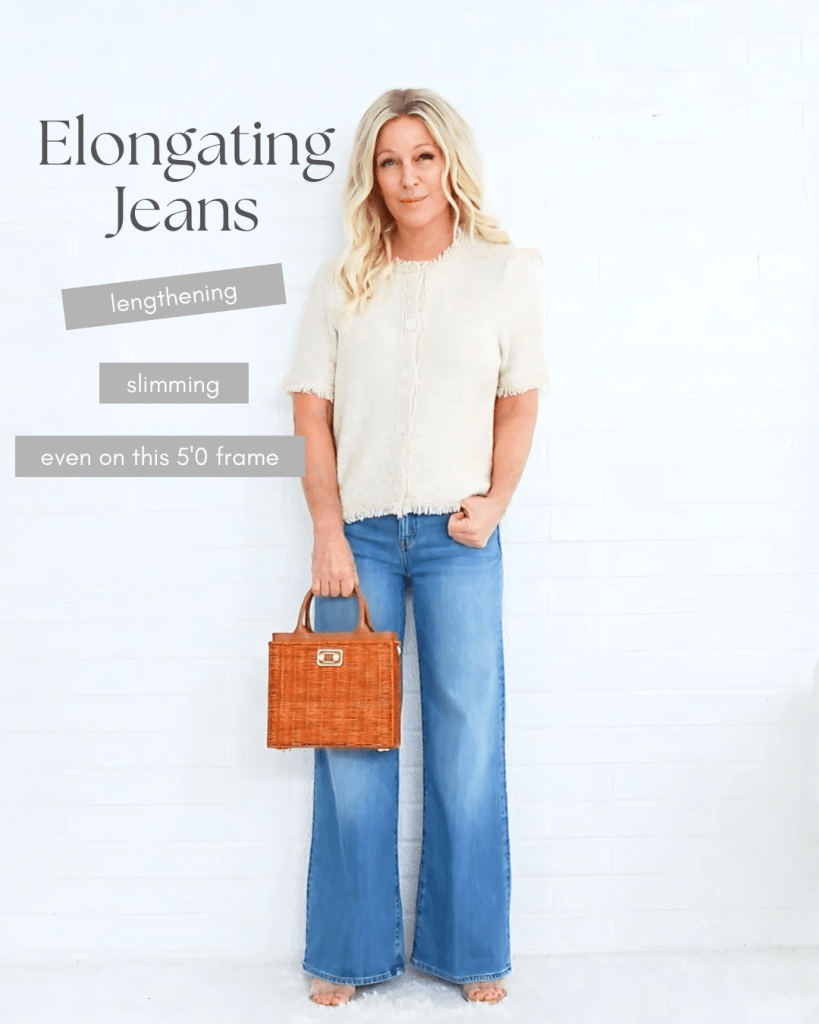 Woman wearing elongating jeans while holding a small brown handbag, showcasing a stylish look against a white background.